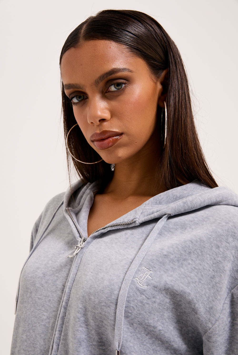 Displays a model wearing the Silver Marl 'Juicy' branded Cotton velour oversized hoodie
