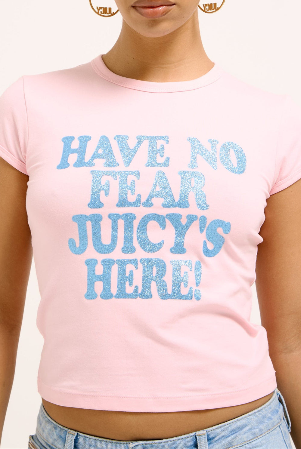 Displays a model wearing the icons Juicy Pink 'Juicy' branded have no fear baby tee 