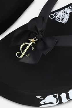 Displays the Black Heritage 'Juicy' branded wedge slide