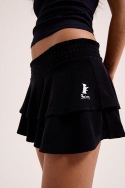 Displays a model wearing the Black Heritage 'Juicy' branded smoked tier skirt