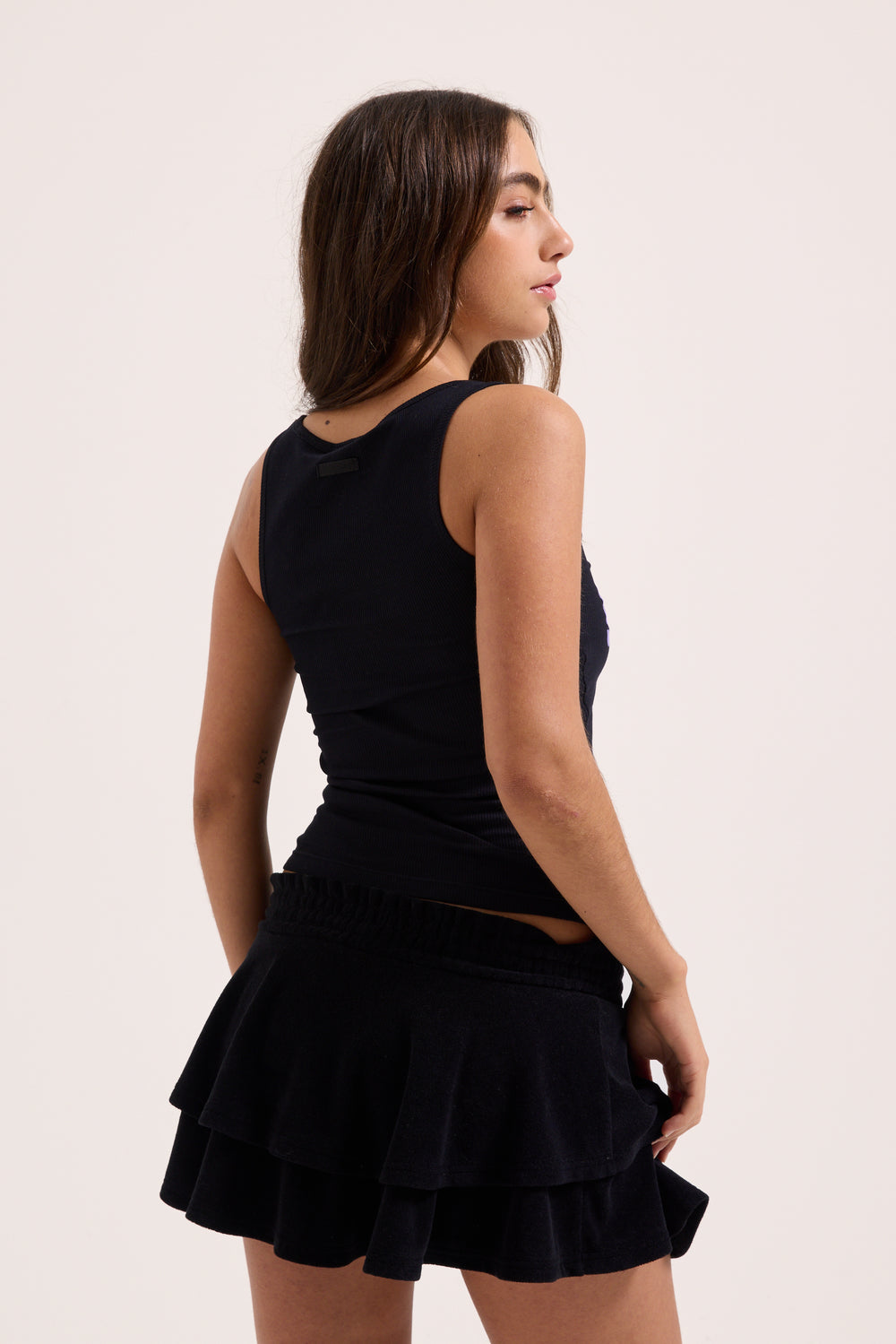 Displays a model wearing the Black Heritage 'Juicy' branded smoked tier skirt