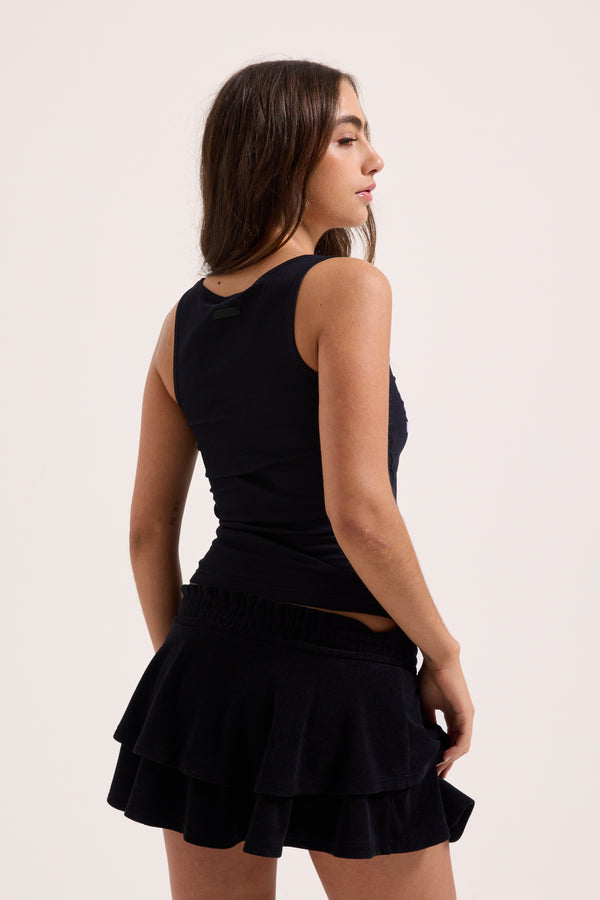 Displays a model wearing the Black Heritage 'Juicy' branded smoked tier skirt