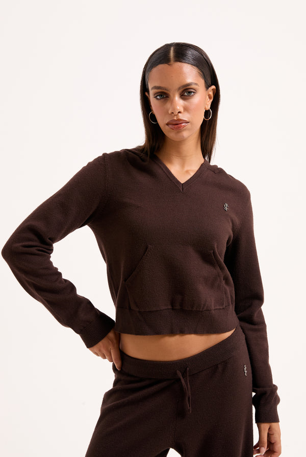 Displays a model wearing the Java 'juicy' branded heritage knit hoodie 