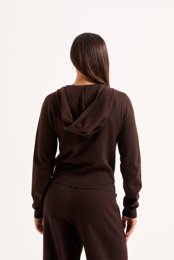 Displays a model wearing the Java 'juicy' branded heritage knit hoodie 