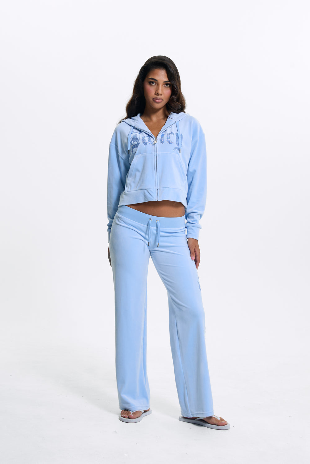 Displays a model wearing the Powder Blue 'Juicy' branded Old Gothic Diamante Og Straight Leg Trackpant