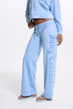Displays a model wearing the Powder Blue 'Juicy' branded Old Gothic Diamante Og Straight Leg Trackpant