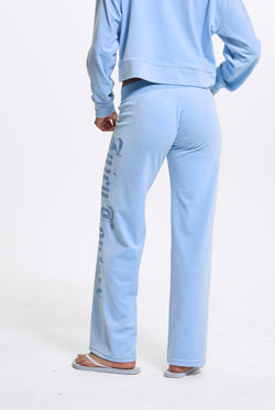 Displays a model wearing the Powder Blue 'Juicy' branded Old Gothic Diamante Og Straight Leg Trackpant