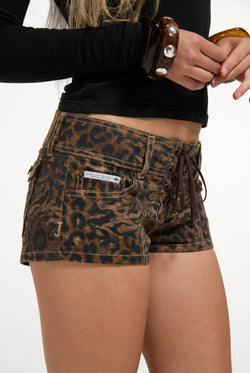 Displays a model wearing the animal 'Juicy' branded denim lace up shorts 