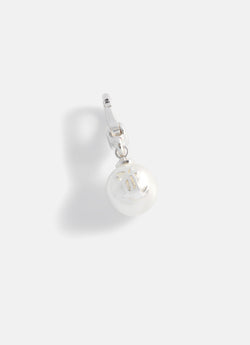Displays the silver 'Juicy' branded JC pearl charm 
