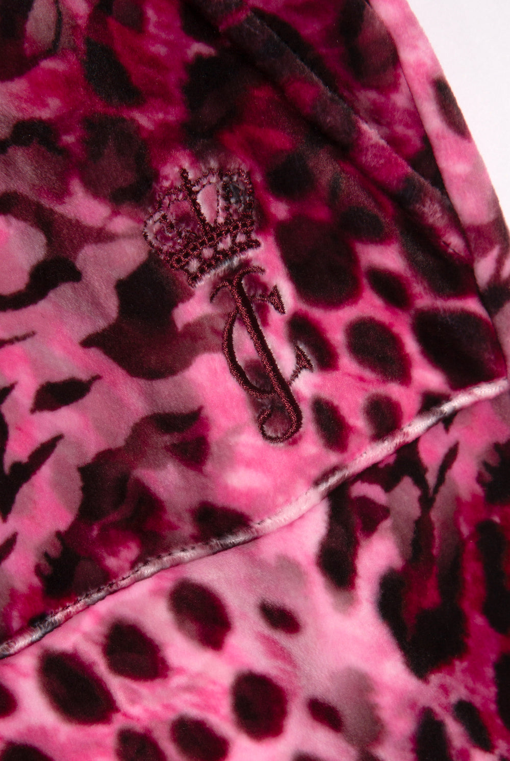 Displays the pink leopard 'Juicy' branded cheetah track bottoms featuring the juicy logo