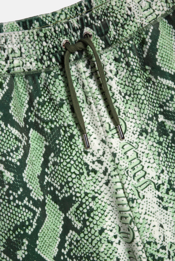 Displays the green snake print 'Juicy' branded diamanté low rise track bottom 