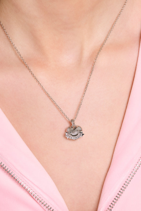 Displays a model wearing the Gold and Silver tone 'juicy' branded heart pendent