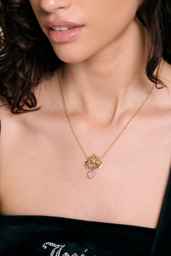 Displays a model wearing the Gold Crown & Crystal 'Juicy' branded heart necklace 