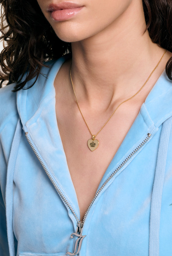 Displays a model wearing the Gold tone 'Juicy' branded reversible heart pendant 