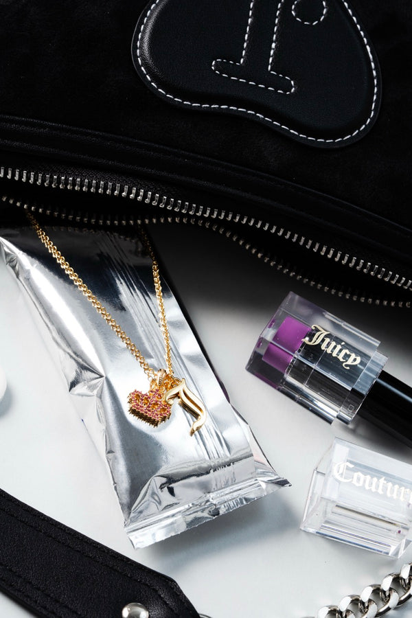Displays the 'Juicy' Gold Tone Crystal Motif Crown & J Charm Pendant with some accesories featured 