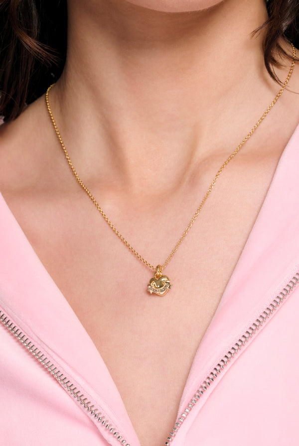 Displays a model wearing the Gold tone 'juicy' branded icon heart small pendant 