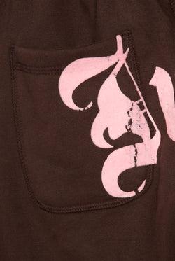 Displays a model wearing the Java 'Juicy' branded relaxed fit flare fleece trackpant featuring the juicy logo