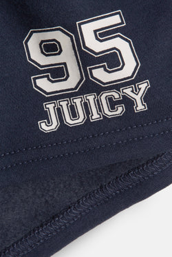 Displays a model wearing the Mood Indigo 'Juicy' branded fleece booty shorts featuring the 95 juicy branding 