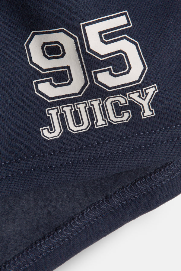 Displays a model wearing the Mood Indigo 'Juicy' branded fleece booty shorts featuring the 95 juicy branding 