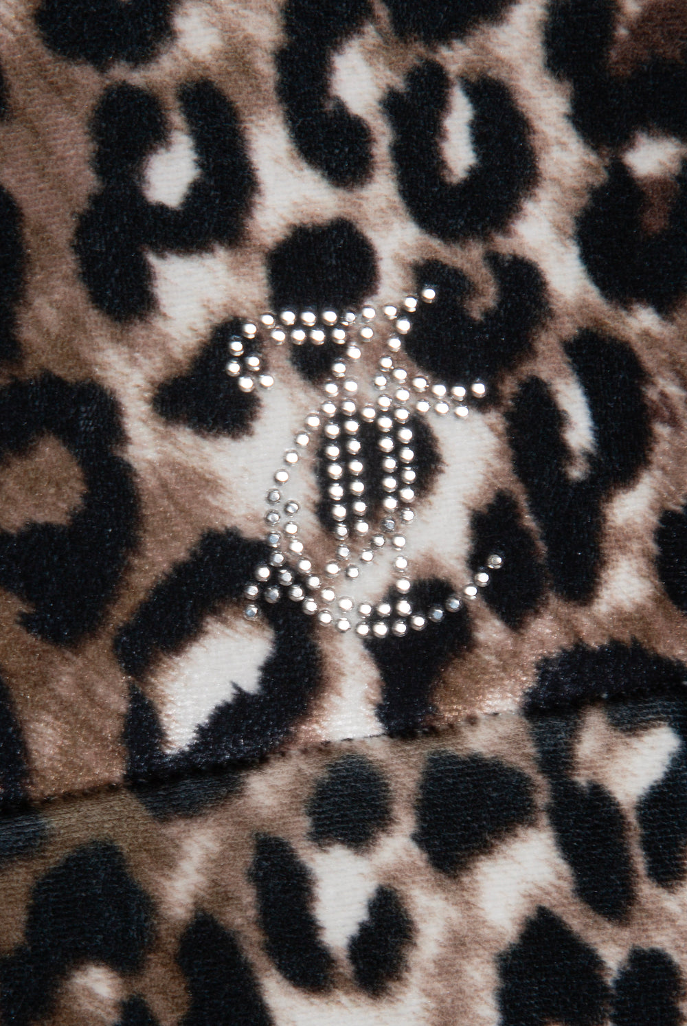 Displays the leopard print velour 'Juicy' branded puffa jacket featuring the juicy Couture logo 