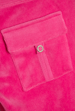 Displays the Nostalgia Pink 'juicy' branded OG straight pocketed capri pants featuring the details on the pockets 