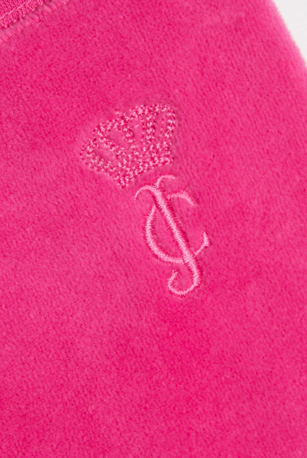 Displays the Nostalgia Pink 'juicy' branded OG straight pocketed capri pants featuring the juicy couture branding