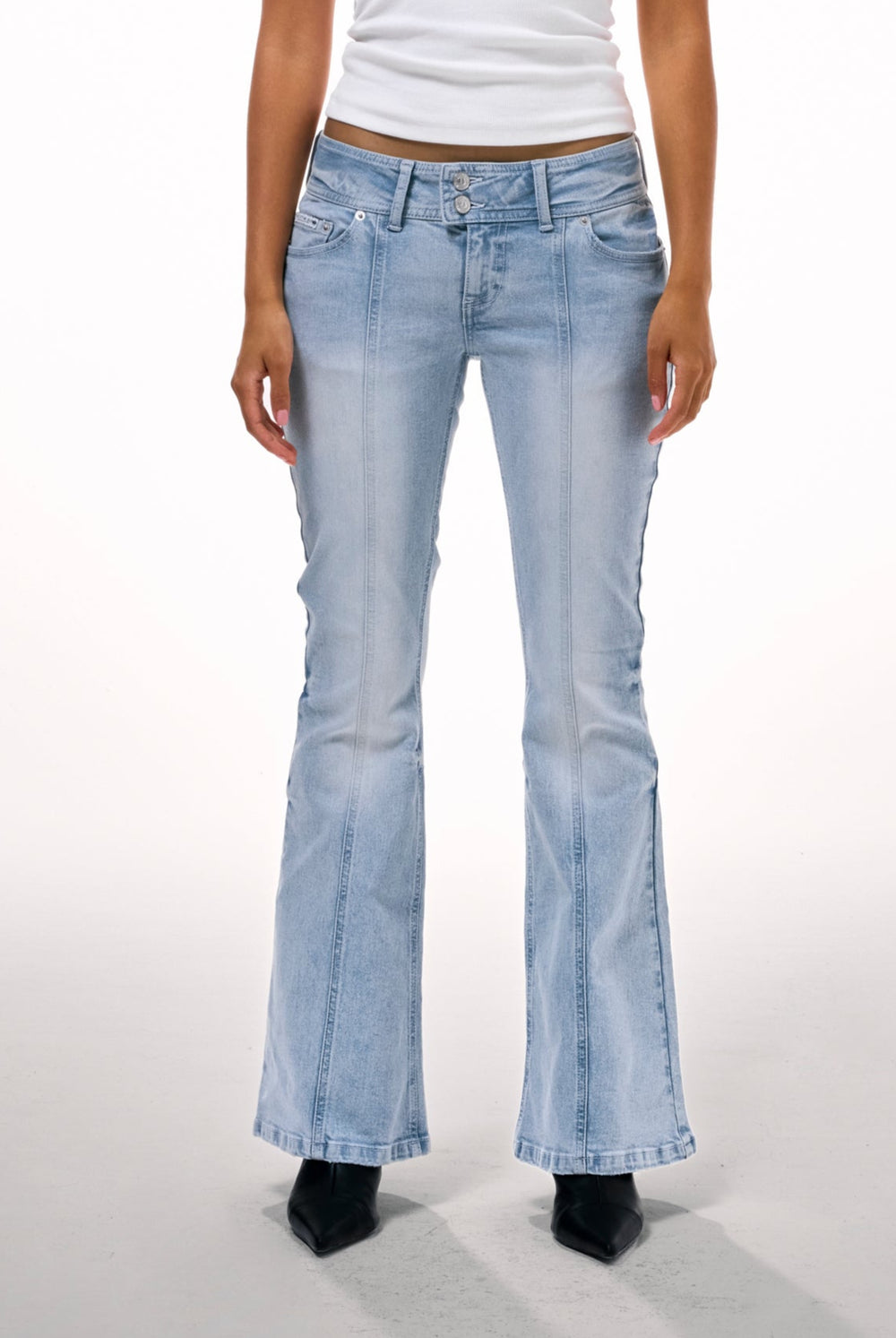 Displays a model wearing the Light wash 'juicy' branded low rise flared embodied jeans 