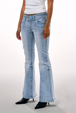 Displays a model wearing the Light wash 'juicy' branded low rise flared embodied jeans 