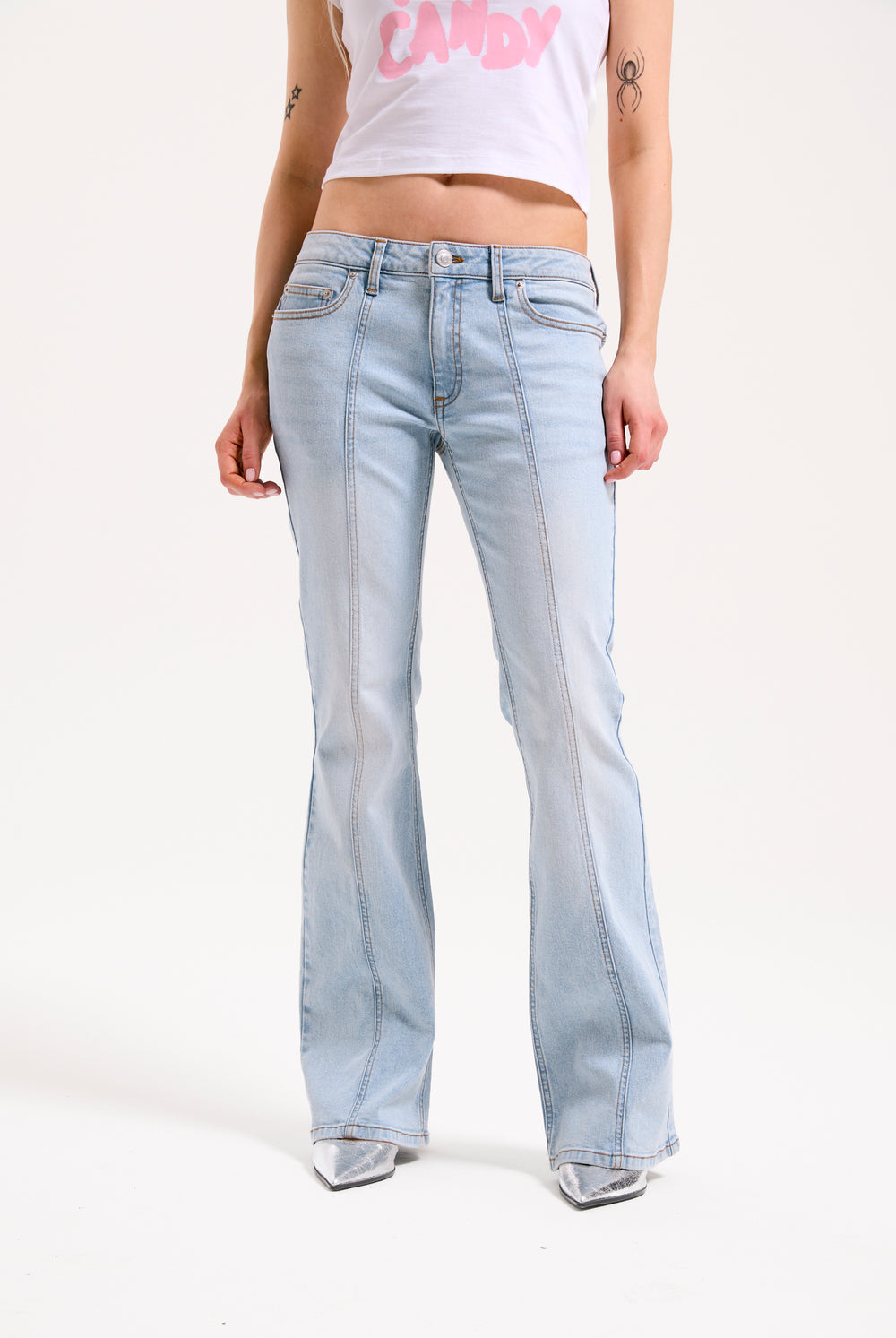 Displays a model wearing the Light Wash 'Juicy' branded Mid Rise crown jeans 