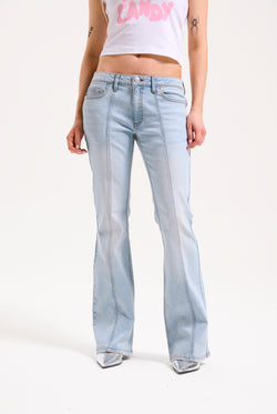 Displays a model wearing the Light Wash 'Juicy' branded Mid Rise crown jeans 