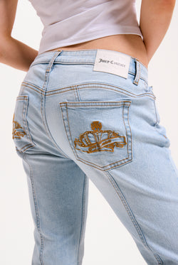 Displays a model wearing the Light Wash 'Juicy' branded Mid Rise crown jeans 