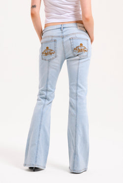 Displays a model wearing the Light Wash 'Juicy' branded Mid Rise crown jeans 