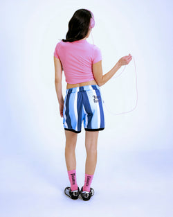 Displays a model wearing the Pink 'Juicy' branded Juicy by pleasures slogan baby tee 