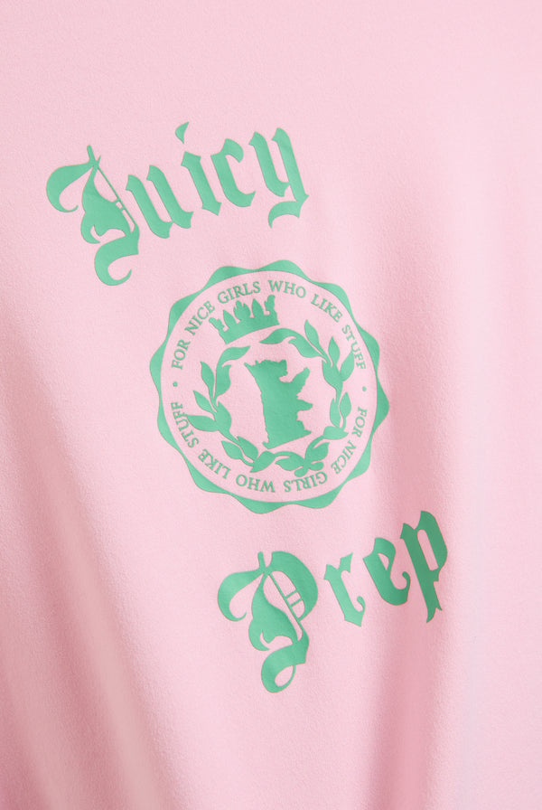 Displays a model wearing the Juicy Pink 'Juicy' prep tee  included in the pyjama set featuring the juicy logo