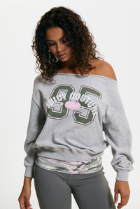 Displays a model wearing the Silver Marl 'Juicy' branded Relaxed Off Shoulder Jumper