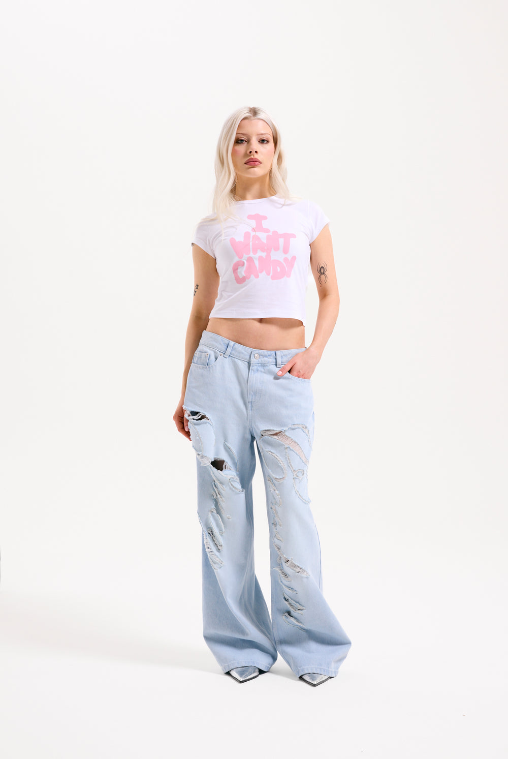 Displays a model wearing the Bleached 'Juicy' branded denim distressed wide leg jeans 