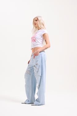 Displays a model wearing the Bleached 'Juicy' branded denim distressed wide leg jeans 