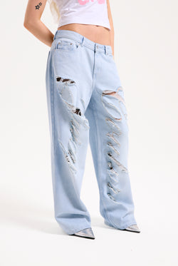 Displays a model wearing the Bleached 'Juicy' branded denim distressed wide leg jeans 
