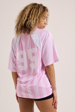 Displays a model wearing the Cherry Blossom 'Juicy' branded football polo shirt