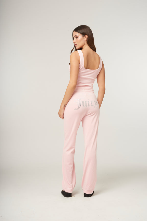 Displays a model wearing the Almond Blossom 'Juicy' branded velour diamanté tracksuit bottom 