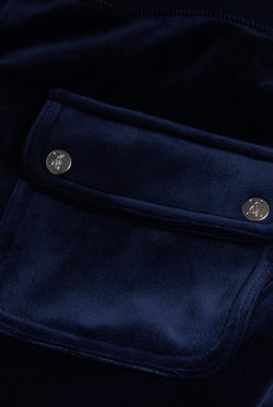 Displays the Night Sky 'Juicy' branded low rise velour track pants featuring a pocket