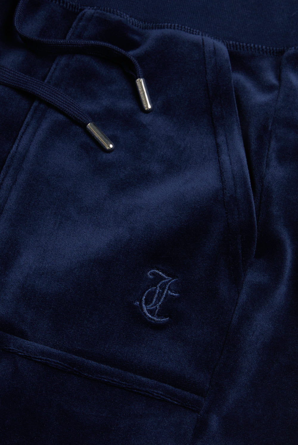 Displays the Night Sky 'Juicy' branded low rise velour track pants featuring the juicy Logo