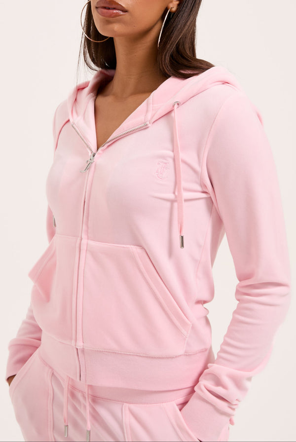 Displays a model wearing the Almond Blossom 'Juicy' branded classic velour Robertson hoodie 