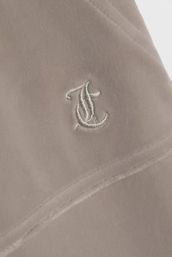 Displays the String 'Juicy' branded low rise flare pocket classic velour track pant featuring the juicy branding