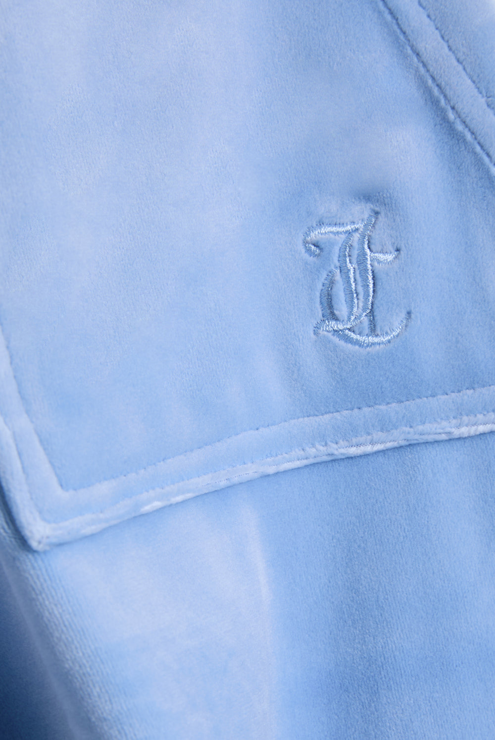 Displays the Della Robia 'Juicy' branded low rise flare classic velour track pant featuring the juicy Couture branding