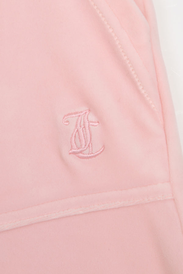 Displays the almond blossom 'Juicy' branded low rise flare classic velour track pant featuring the juicy Couture logo
