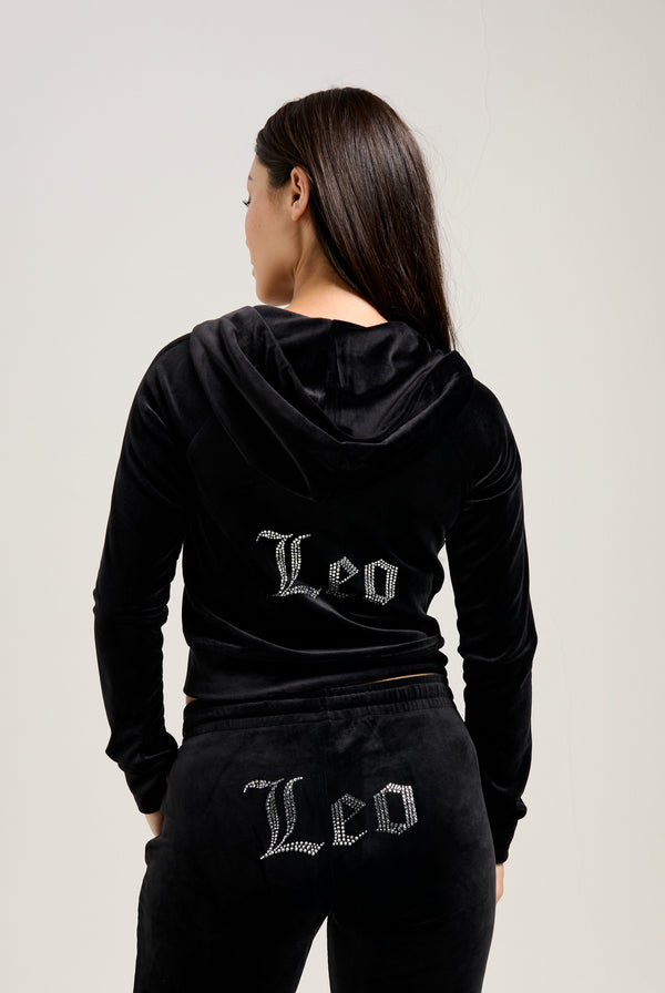 Displays a model wearing the Black 'Juicy' branded 'LEO' Diamanté velour zip through hoodie 