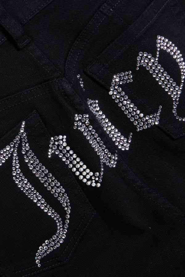 Displays a model wearing the Black stretch 'Juicy' branded twill low rise flare jeans featuring the juicy branding 