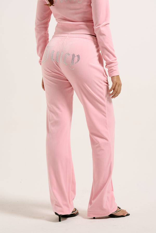 Displays a model wearing the Juicy Pink 'Juicy' branded velour diamanté tracksuit bottoms 