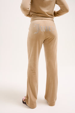 Displays a model wearing the Nomad 'Juicy' branded Velour Diamanté tracksuit bottom 